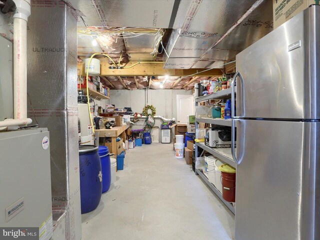 basement with stainless steel refrigerator