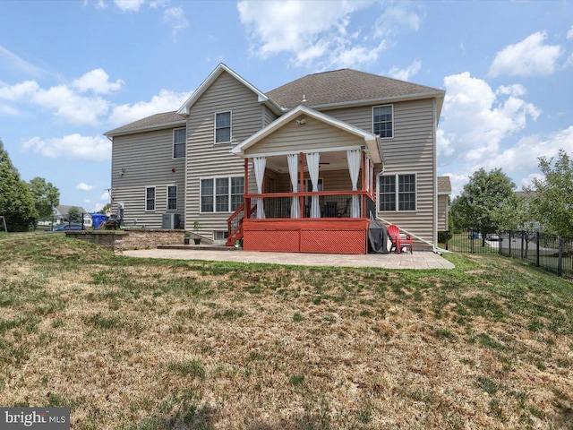 rear view of property with a patio, central AC, and a lawn