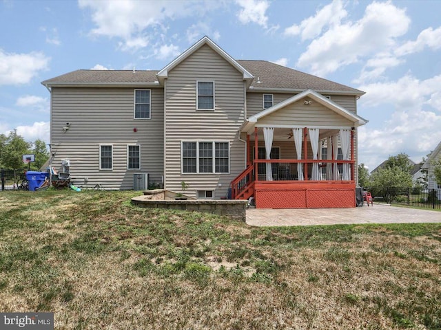 back of property featuring a patio area and a yard