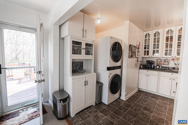 washroom with stacked washing maching and dryer