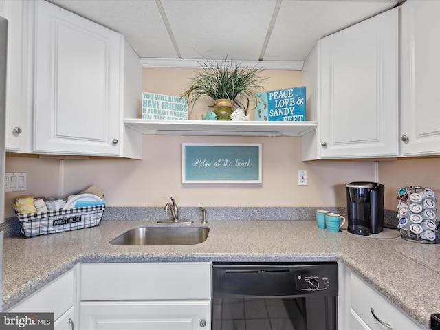 kitchen with black dishwasher, sink, and white cabinets