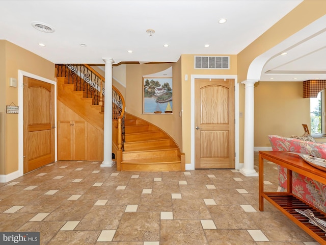 foyer entrance featuring decorative columns