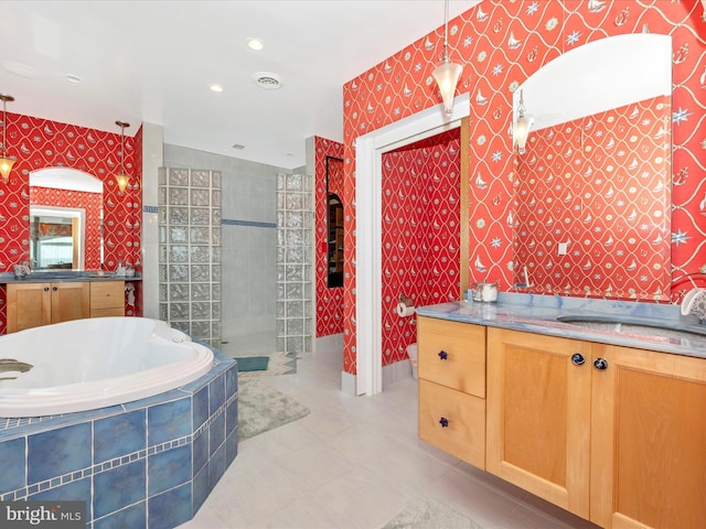 bathroom featuring vanity, tile patterned floors, and separate shower and tub