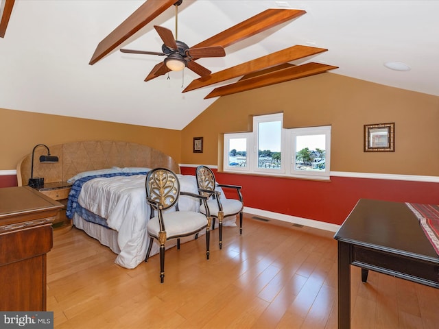 bedroom featuring lofted ceiling with beams and light wood-type flooring