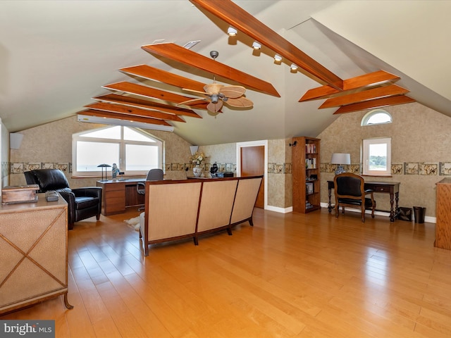 living room with vaulted ceiling with beams, ceiling fan, and light wood-type flooring