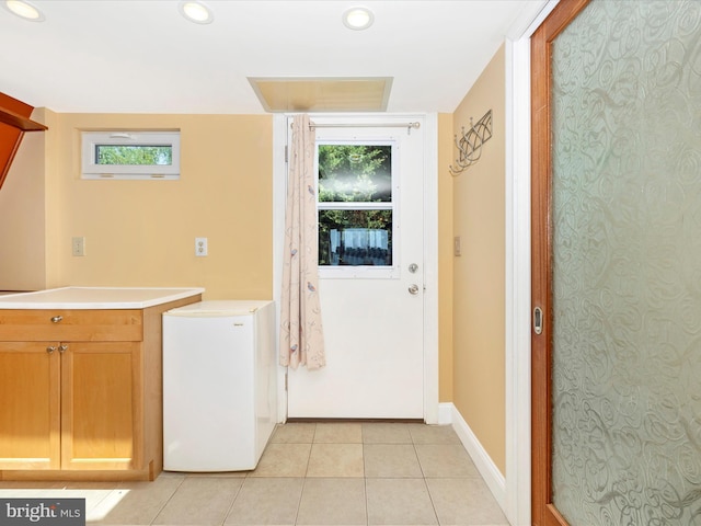 laundry area with light tile patterned floors