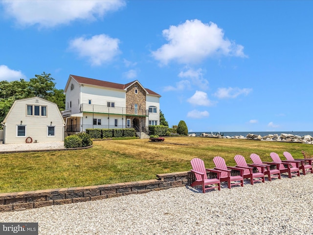 rear view of property featuring a lawn