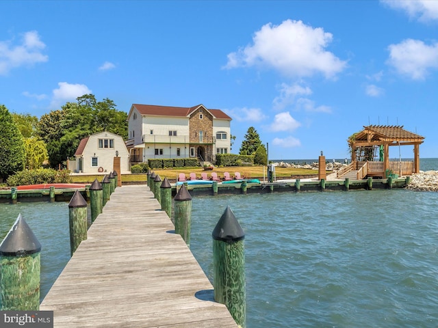 dock area with a water view and a pergola