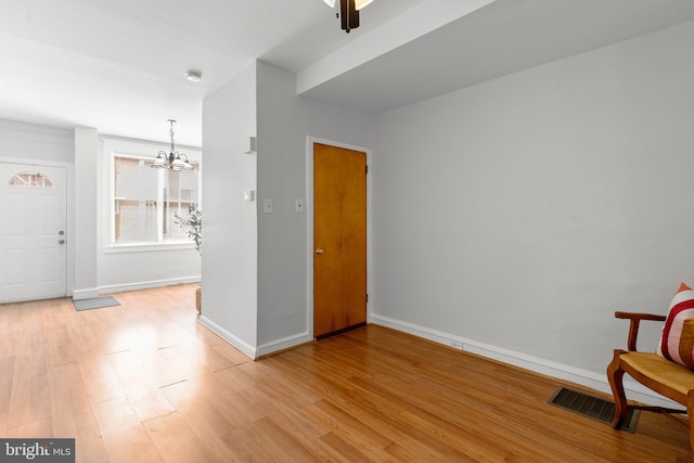 interior space with a chandelier and light wood-type flooring