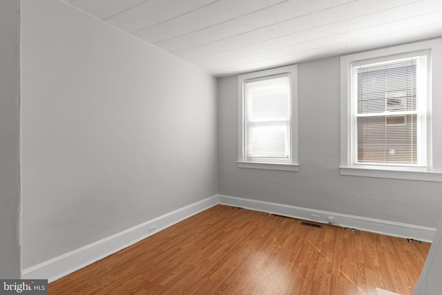 unfurnished room with light wood-type flooring