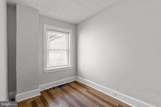 unfurnished room with hardwood / wood-style floors