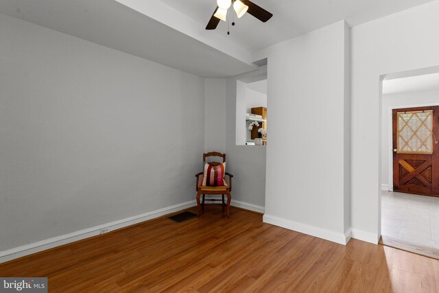 unfurnished room featuring hardwood / wood-style floors and ceiling fan