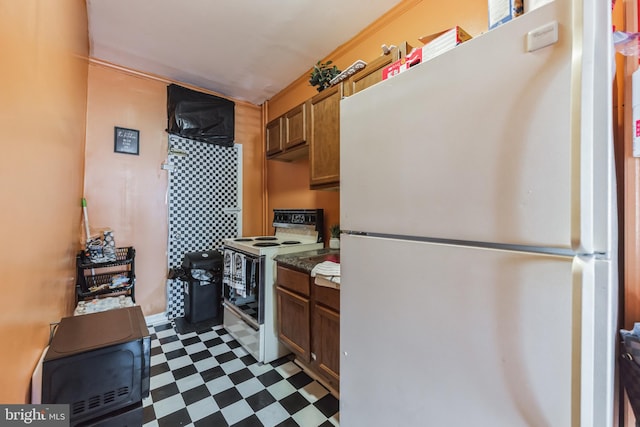 kitchen featuring white appliances and light tile patterned floors