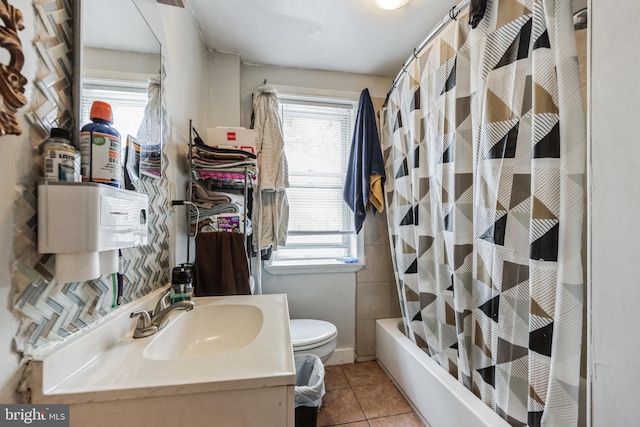 full bathroom featuring tile patterned floors, toilet, vanity, and shower / tub combo with curtain