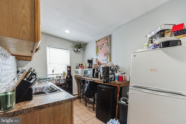 kitchen featuring light tile patterned flooring and white refrigerator