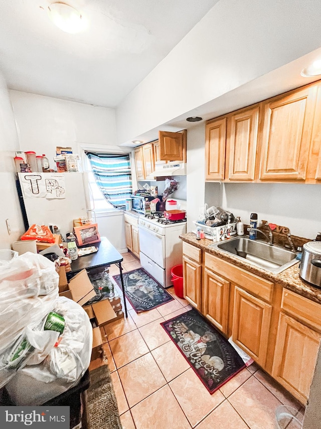 kitchen featuring sink, white appliances, and light tile patterned floors