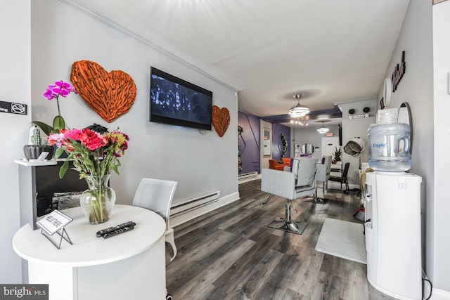 living room with ceiling fan, baseboard heating, and hardwood / wood-style floors