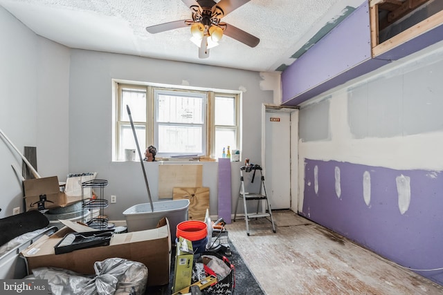 interior space with a textured ceiling and ceiling fan