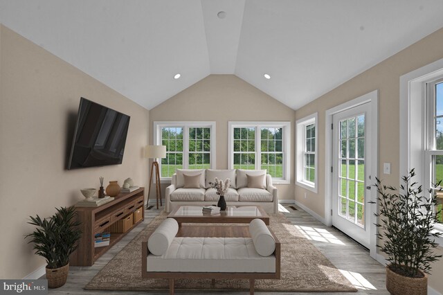 living room featuring high vaulted ceiling and light hardwood / wood-style floors