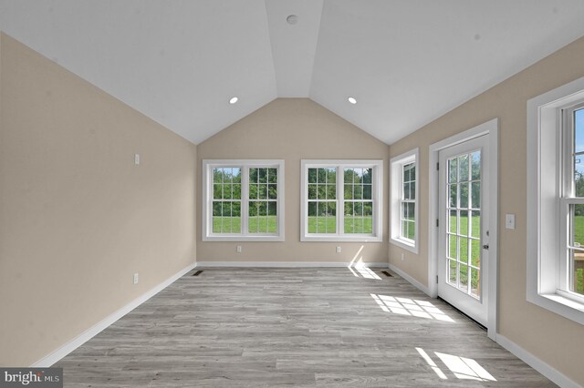 unfurnished sunroom with vaulted ceiling and plenty of natural light