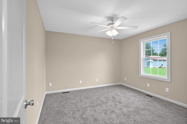 unfurnished room with ceiling fan and carpet floors