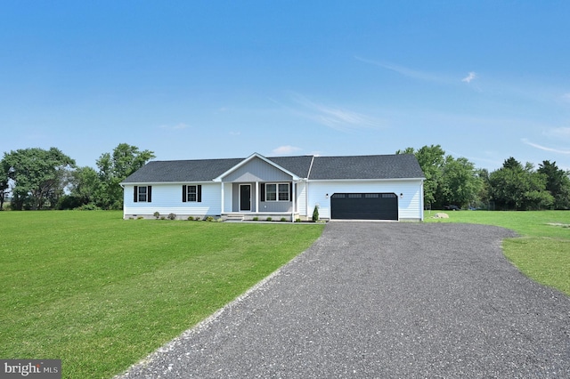 view of front of property with a garage and a front lawn