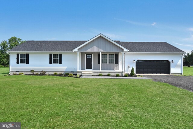 ranch-style house featuring a front lawn and a garage