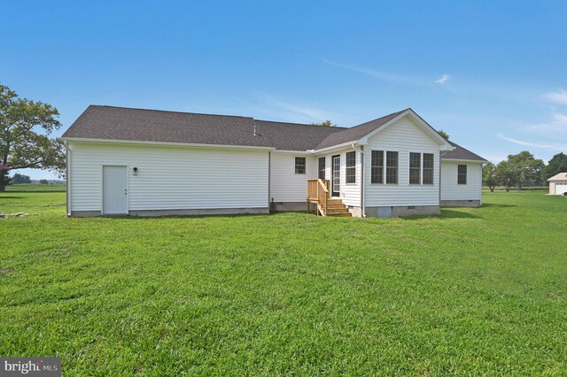 rear view of house with a yard