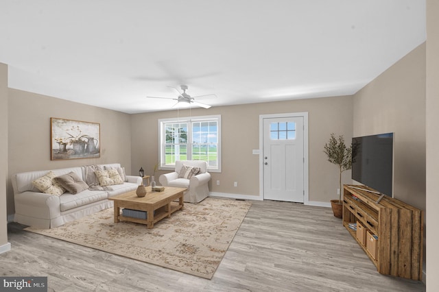 living room featuring light hardwood / wood-style flooring and ceiling fan