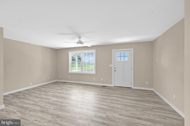 unfurnished room with ceiling fan and light wood-type flooring