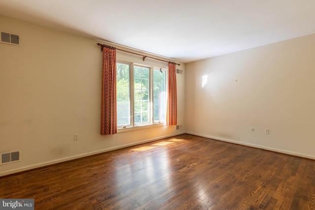 empty room featuring dark hardwood / wood-style flooring