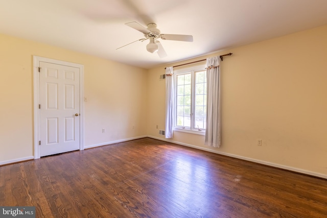 empty room featuring ceiling fan and dark hardwood / wood-style flooring