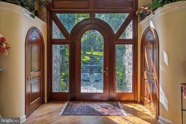 entryway with light wood-type flooring and a healthy amount of sunlight