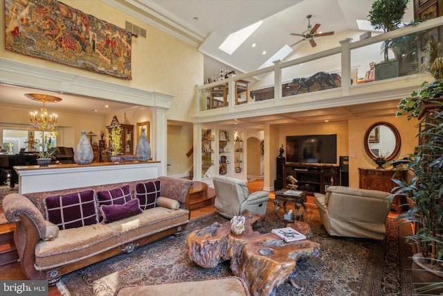 living room featuring visible vents, stairway, ornamental molding, high vaulted ceiling, and ceiling fan with notable chandelier