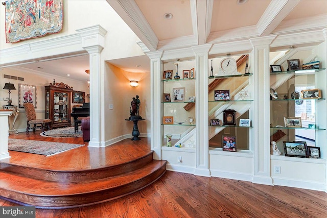 interior space featuring built in shelves, wood finished floors, visible vents, ornate columns, and crown molding