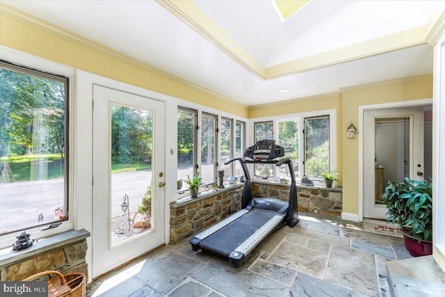 exercise area with stone tile floors and crown molding