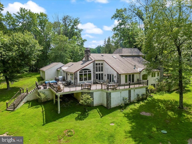 rear view of property with a shingled roof, stairs, a yard, a wooden deck, and a chimney