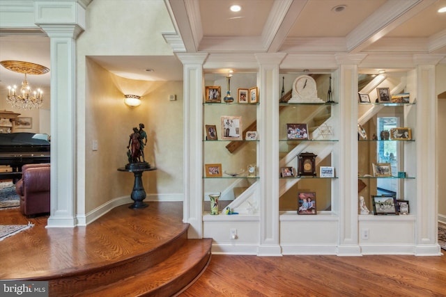 details with ornate columns, crown molding, built in shelves, and wood finished floors