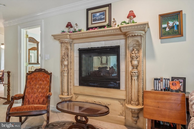 sitting room featuring ornamental molding and a tile fireplace