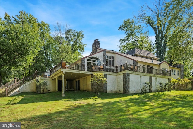 back of house featuring a wooden deck, a chimney, stairway, and a yard