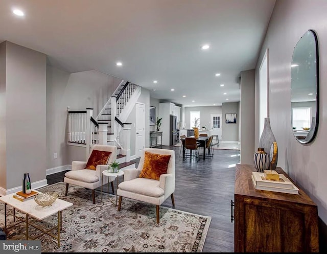 living room featuring dark hardwood / wood-style floors and a wealth of natural light