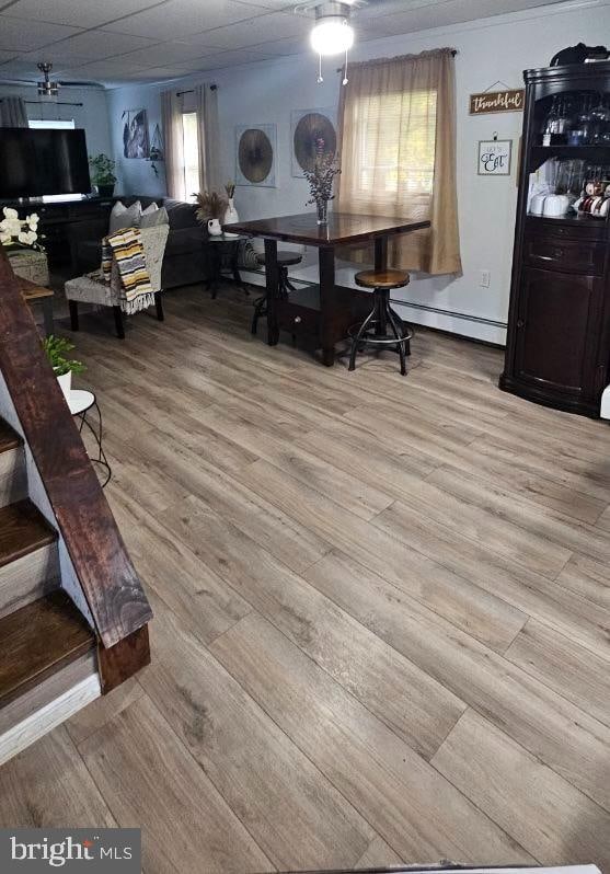 dining room with ceiling fan and light wood-type flooring