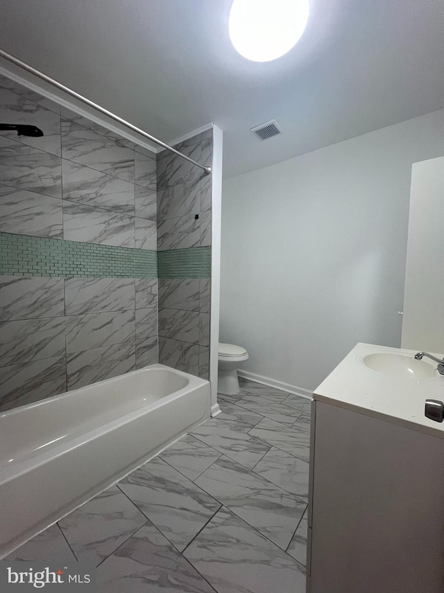 full bathroom featuring vanity, toilet, and tiled shower / bath