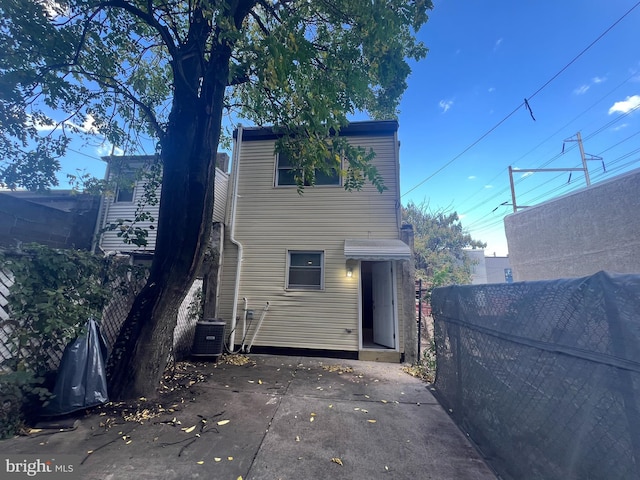 rear view of house with cooling unit