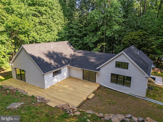 back of house with a wooden deck