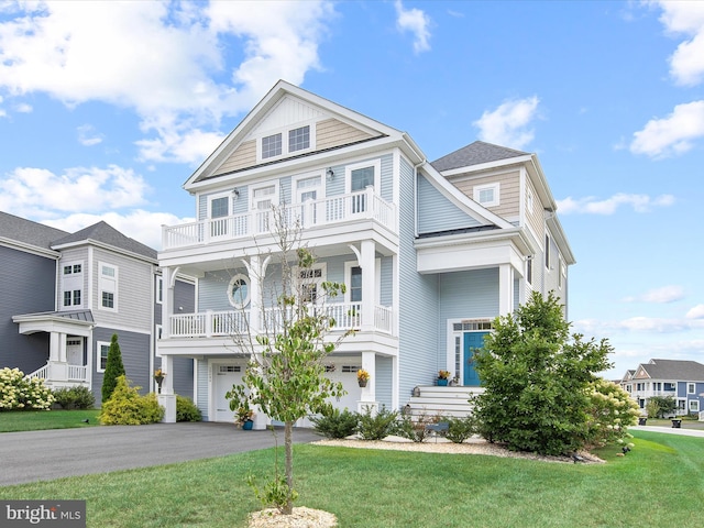 view of front of home featuring a garage, a front lawn, and a porch