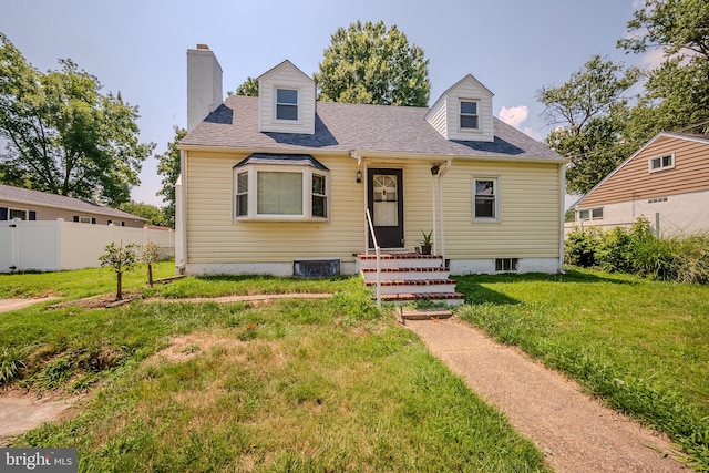 new england style home featuring a front lawn