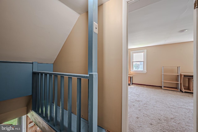 interior space with carpet floors and lofted ceiling