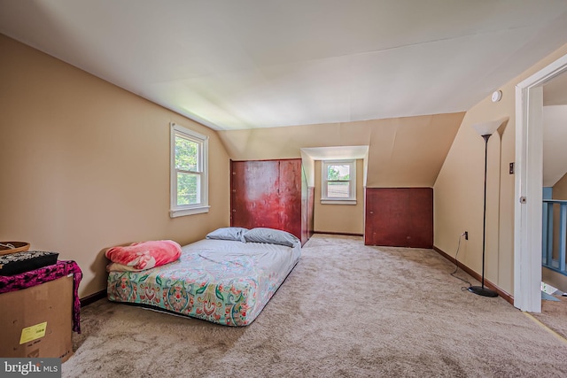 carpeted bedroom featuring lofted ceiling