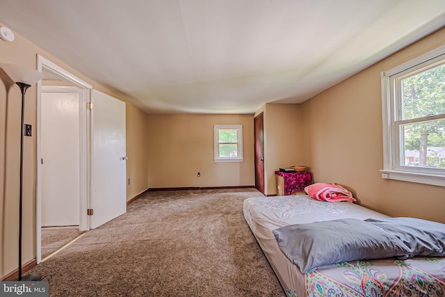 carpeted bedroom featuring multiple windows